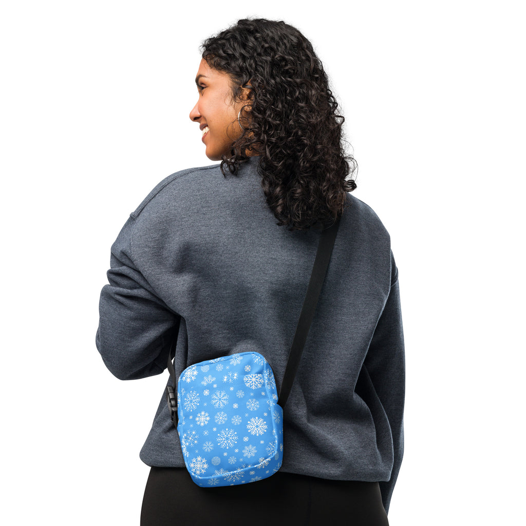 Blue snowflake winter women’s crossbody purse with white snowflake pattern on blue fabric for seasonal use