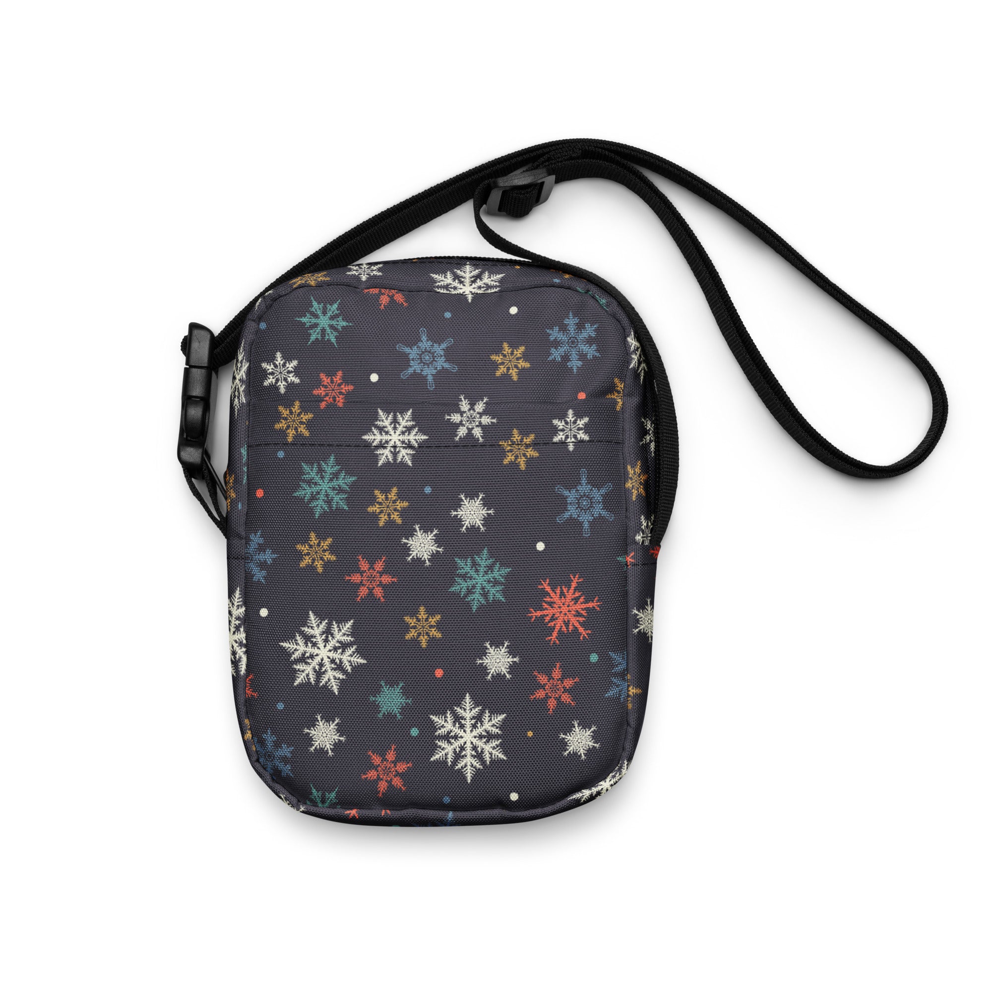 A dark gray girls colorful snowflakes crossbody purse with multicolored white red blue and gold snowflake pattern