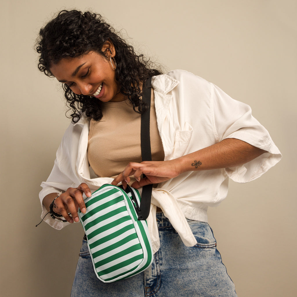 Green and white candy stripe crossbody purse with black strap designed for women’s festive Christmas use