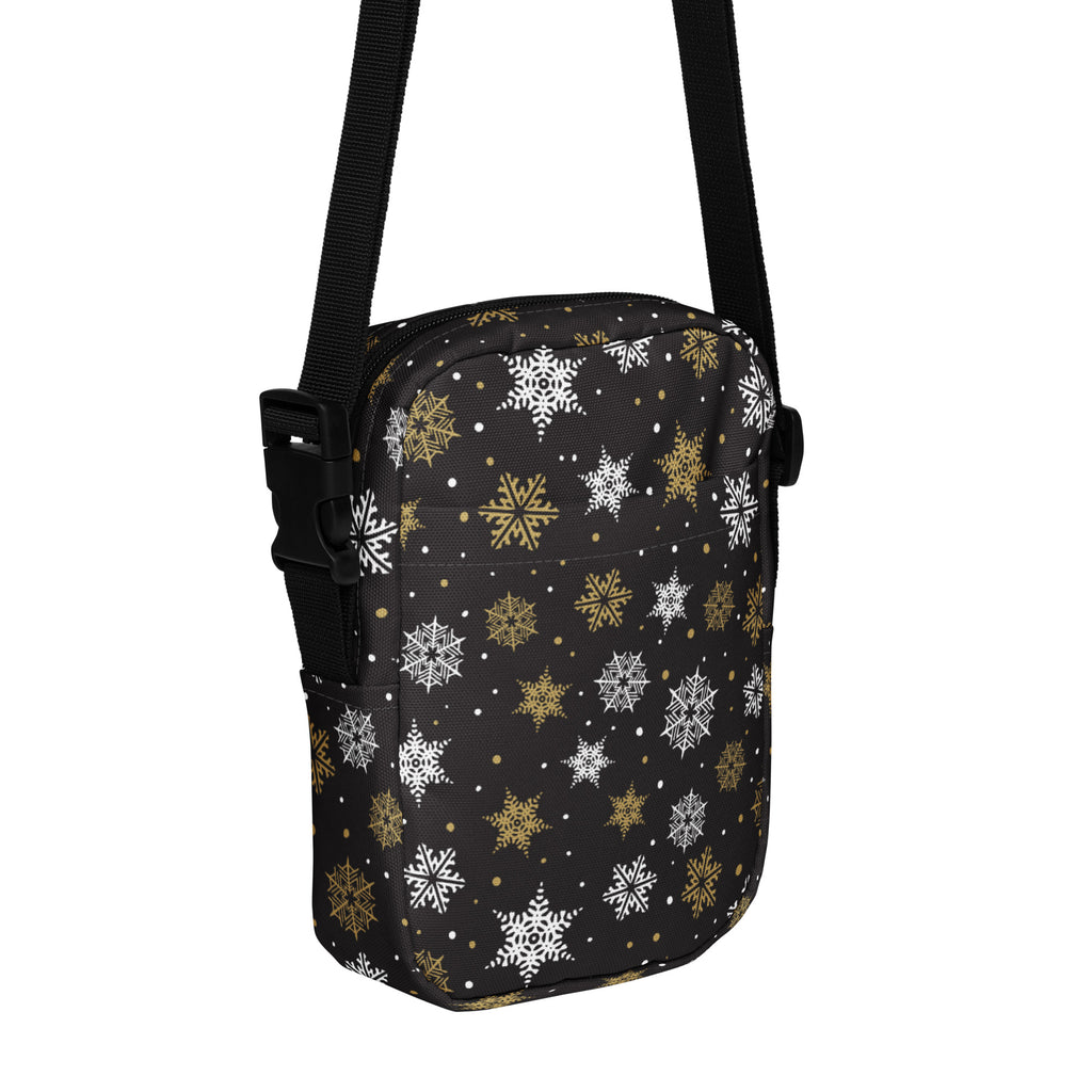 Girls black crossbody purse featuring a festive white and gold snowflake pattern for holiday use
