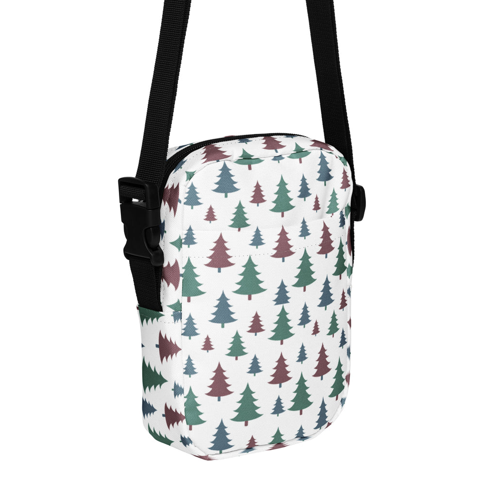 White crossbody bag with multicolored pine tree pattern in green and maroon for winter and christmas use