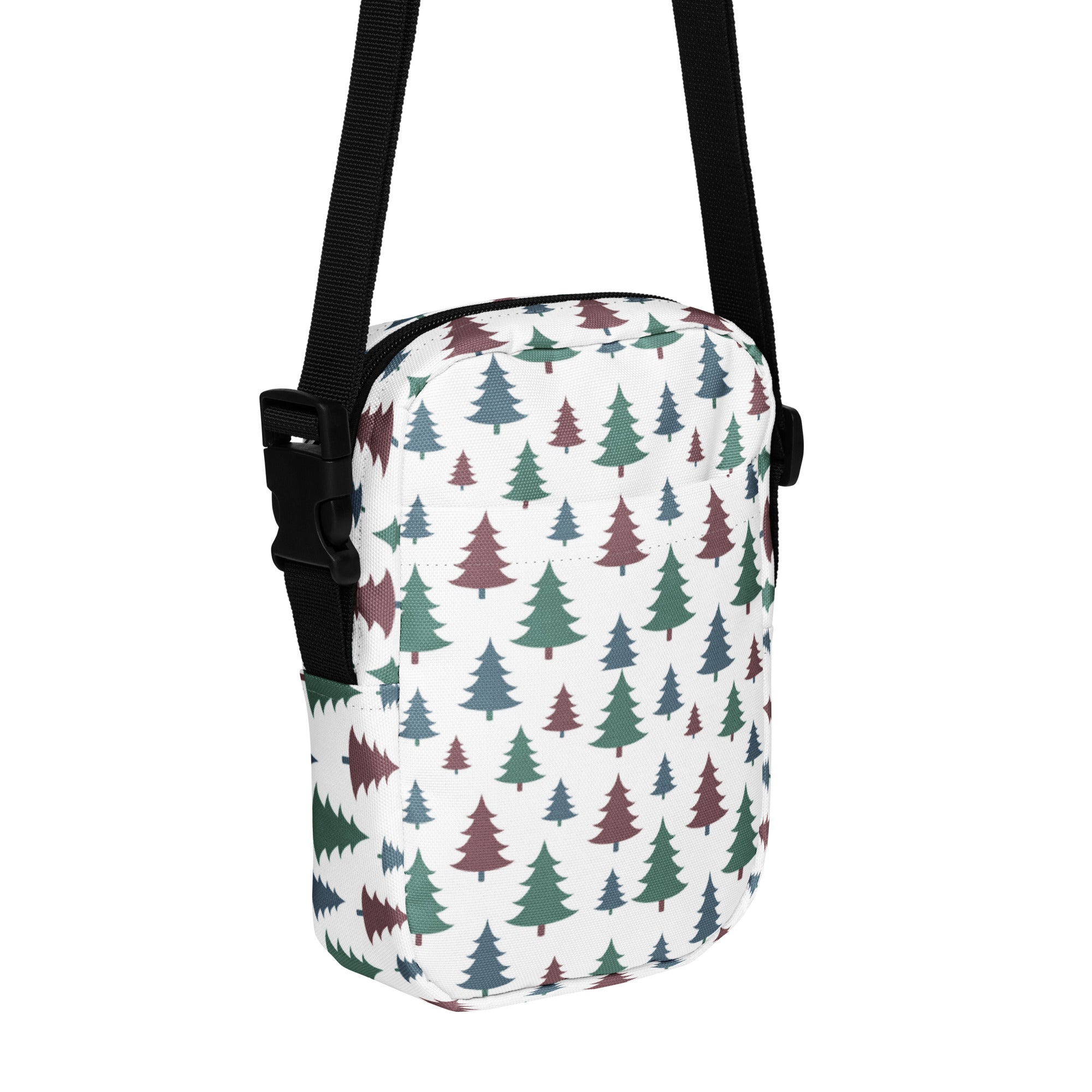 White crossbody bag with multicolored pine tree pattern in green and maroon for winter and christmas use