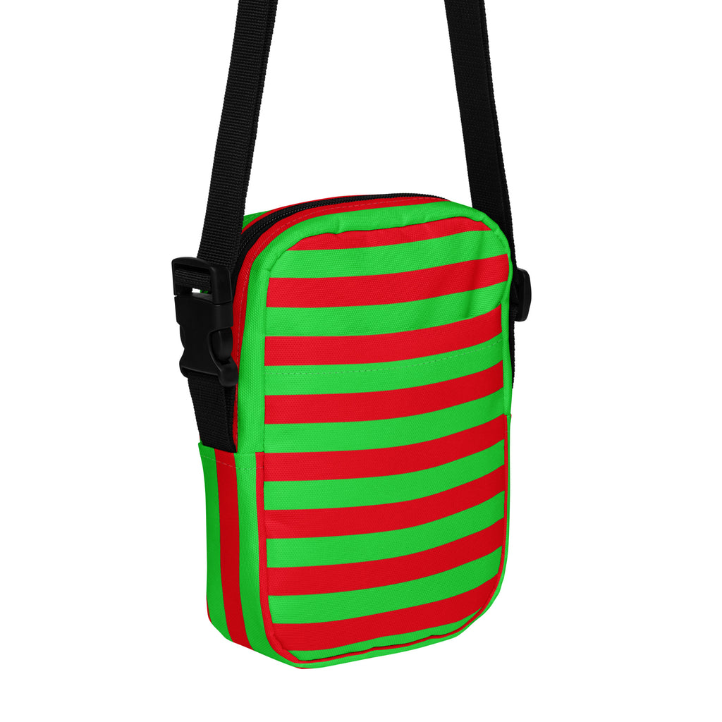 A vibrant red and green striped crossbody purse with a black adjustable strap for women during Christmas