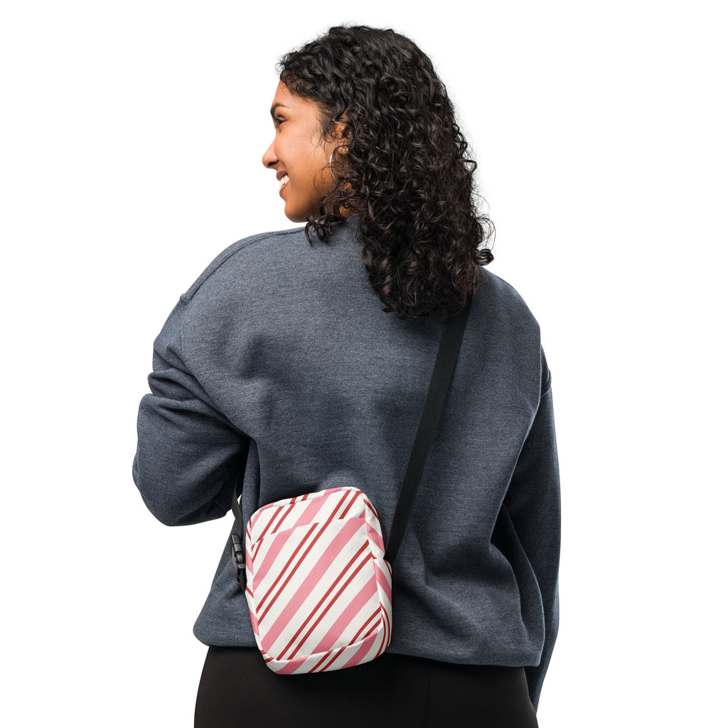 Pink candy cane stripe christmas women’s crossbody purse with pink and white diagonal stripes and black adjustable strap