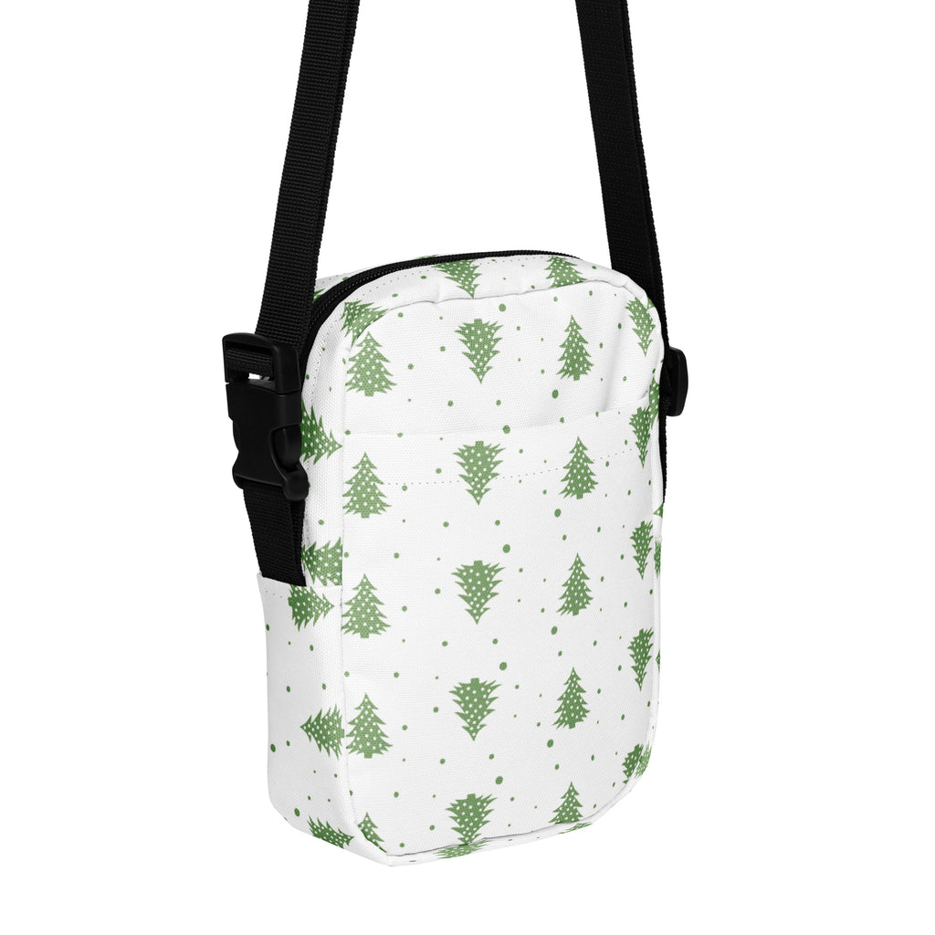 White crossbody bag with green pine tree and dot pattern and black adjustable strap for christmas winter use