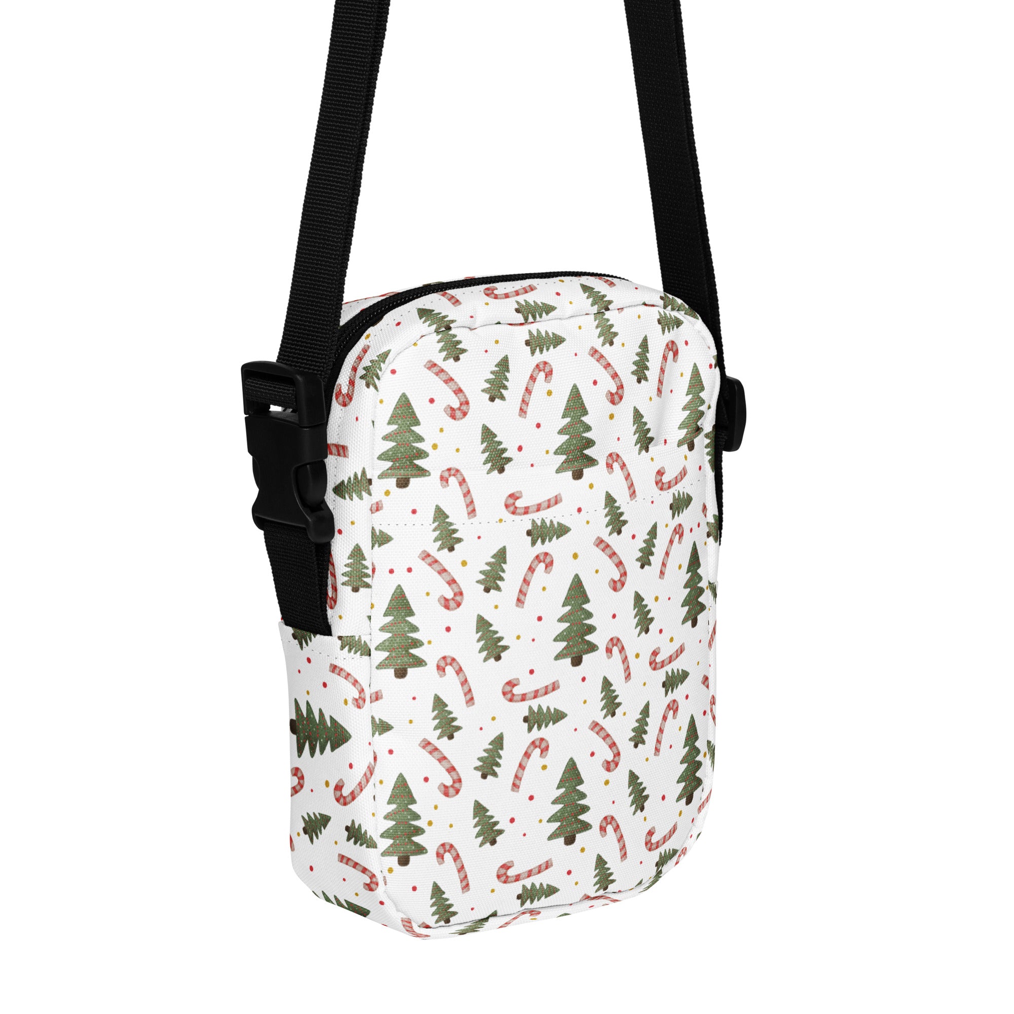 White crossbody bag with festive green pine trees and red and white striped candy canes pattern for holiday use