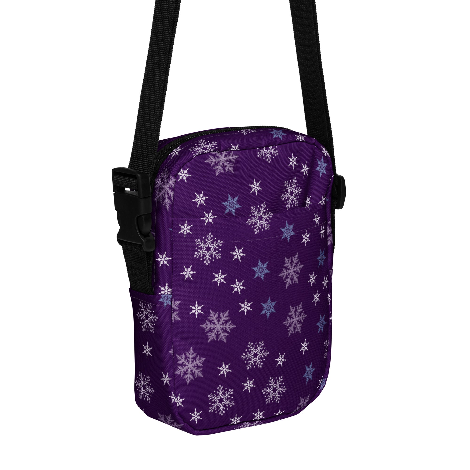 Christmas purple snowflake winter women’s crossbody purse with white and light blue snowflake pattern and black adjustable straps