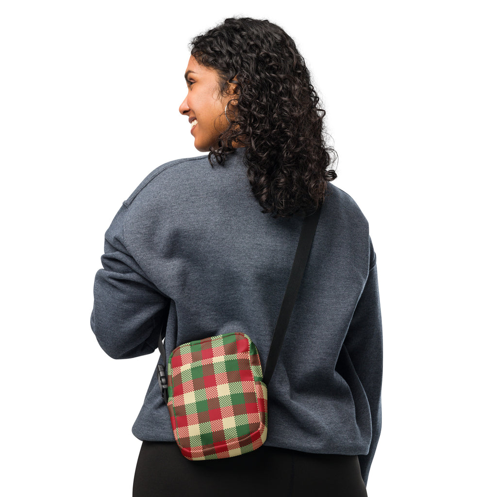 A Christmas plaid winter women’s crossbody purse in red green and cream with a durable fabric finish
