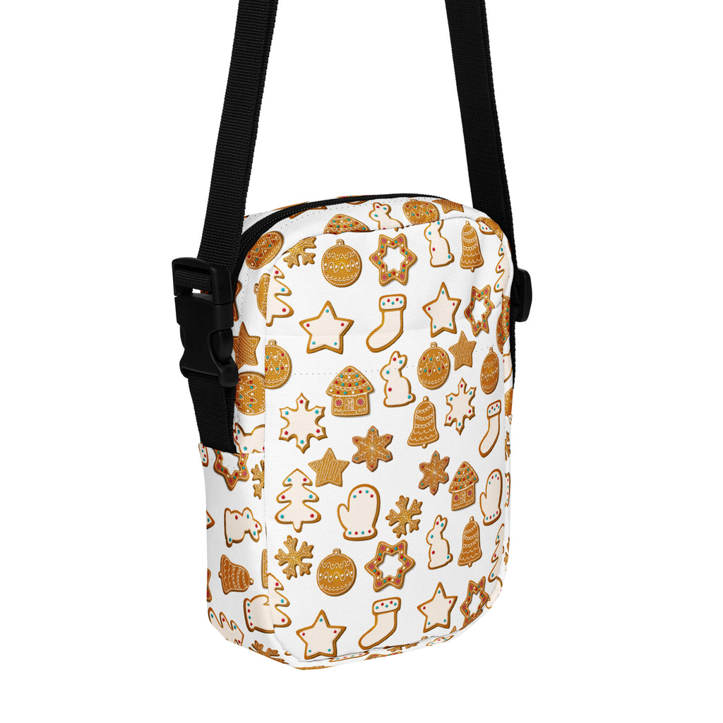 White crossbody bag with festive gingerbread cookie pattern in golden brown and beige with black adjustable straps