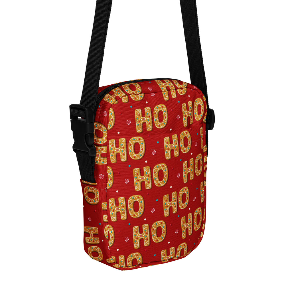 Red ho ho ho christmas women’s crossbody purse with festive gold and green pattern and black adjustable straps