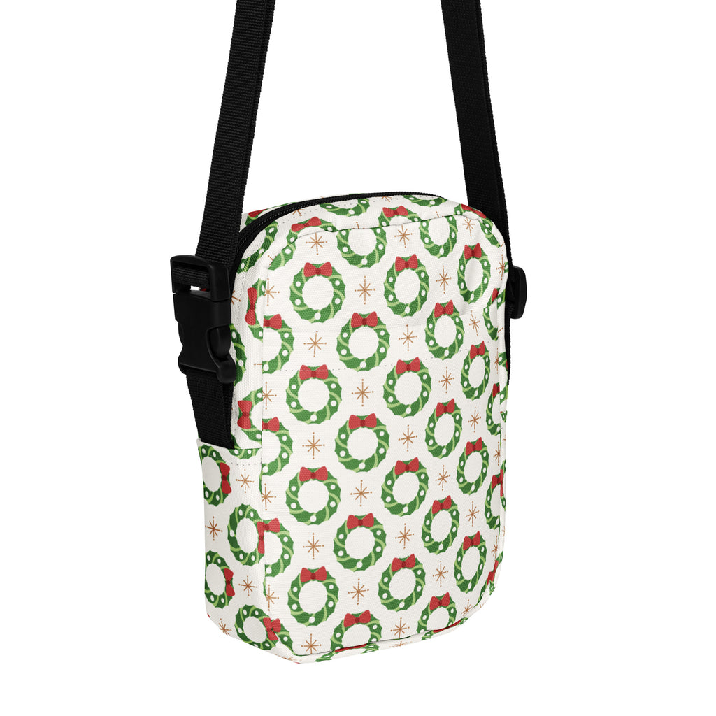 Girls Christmas wreath crossbody purse in white with green wreath pattern red bows gold starbursts and black strap