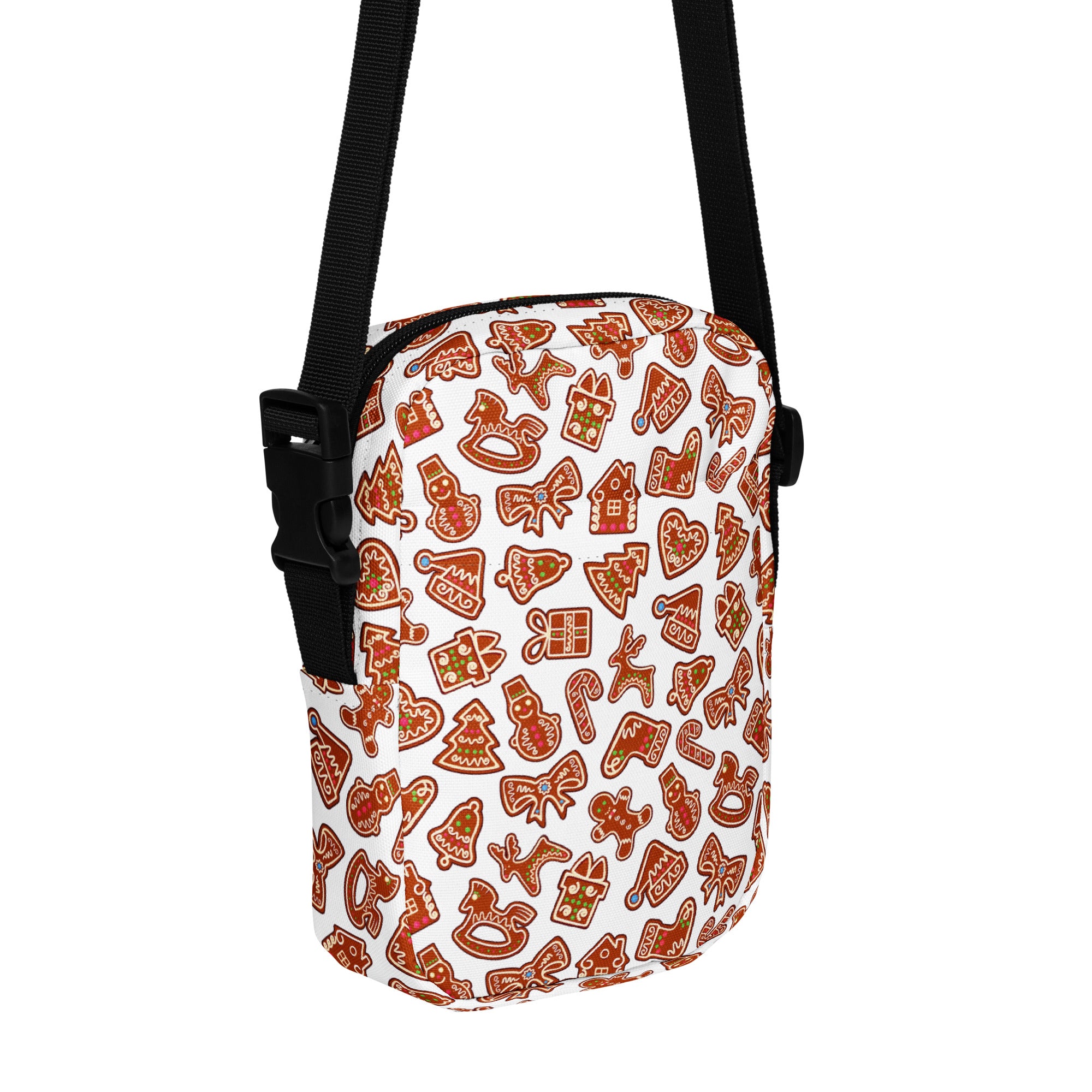 White crossbody bag with festive gingerbread cookie pattern in brown and orange featuring black adjustable straps