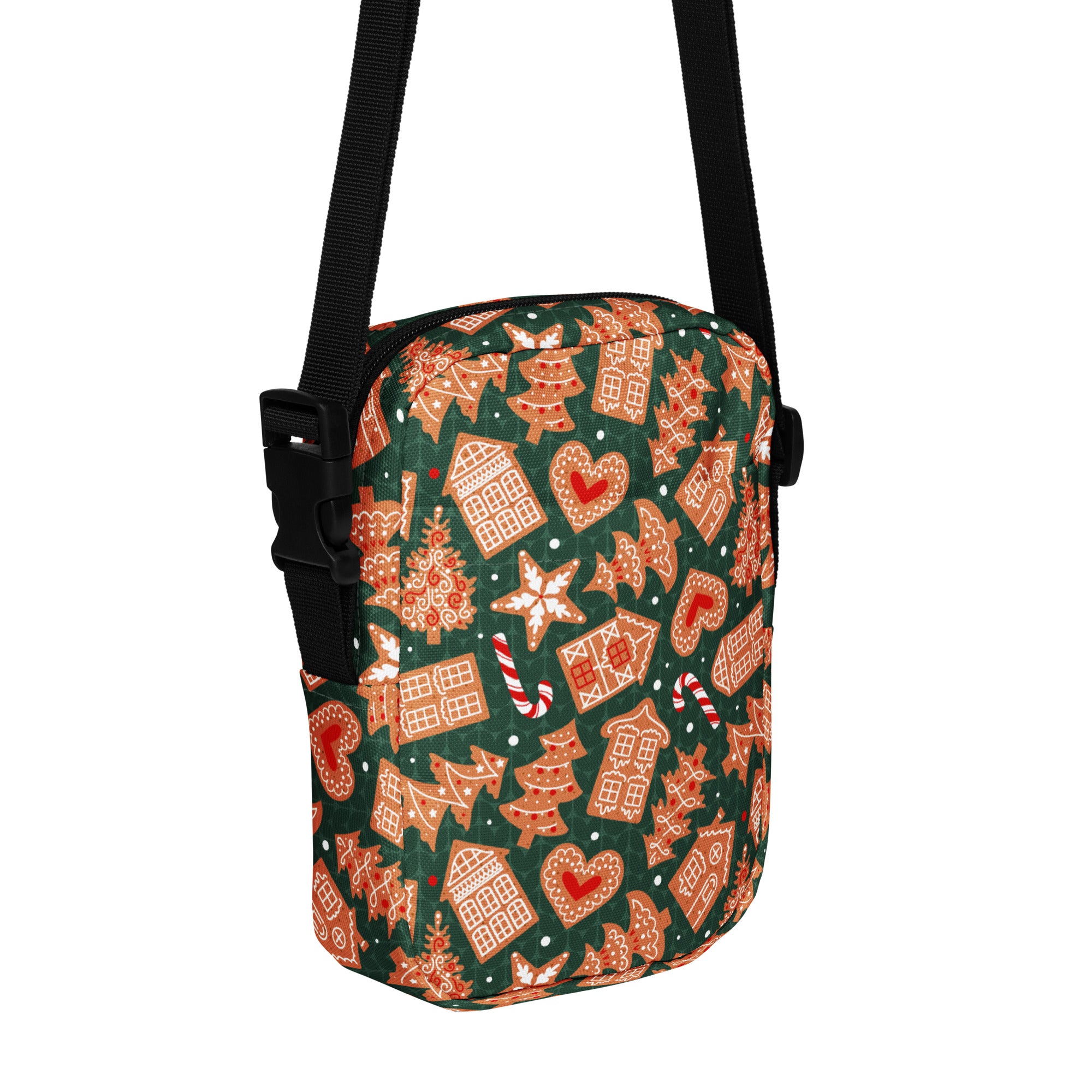 Girls green crossbody purse with festive gingerbread houses candy canes and stars pattern in warm orange and red tones