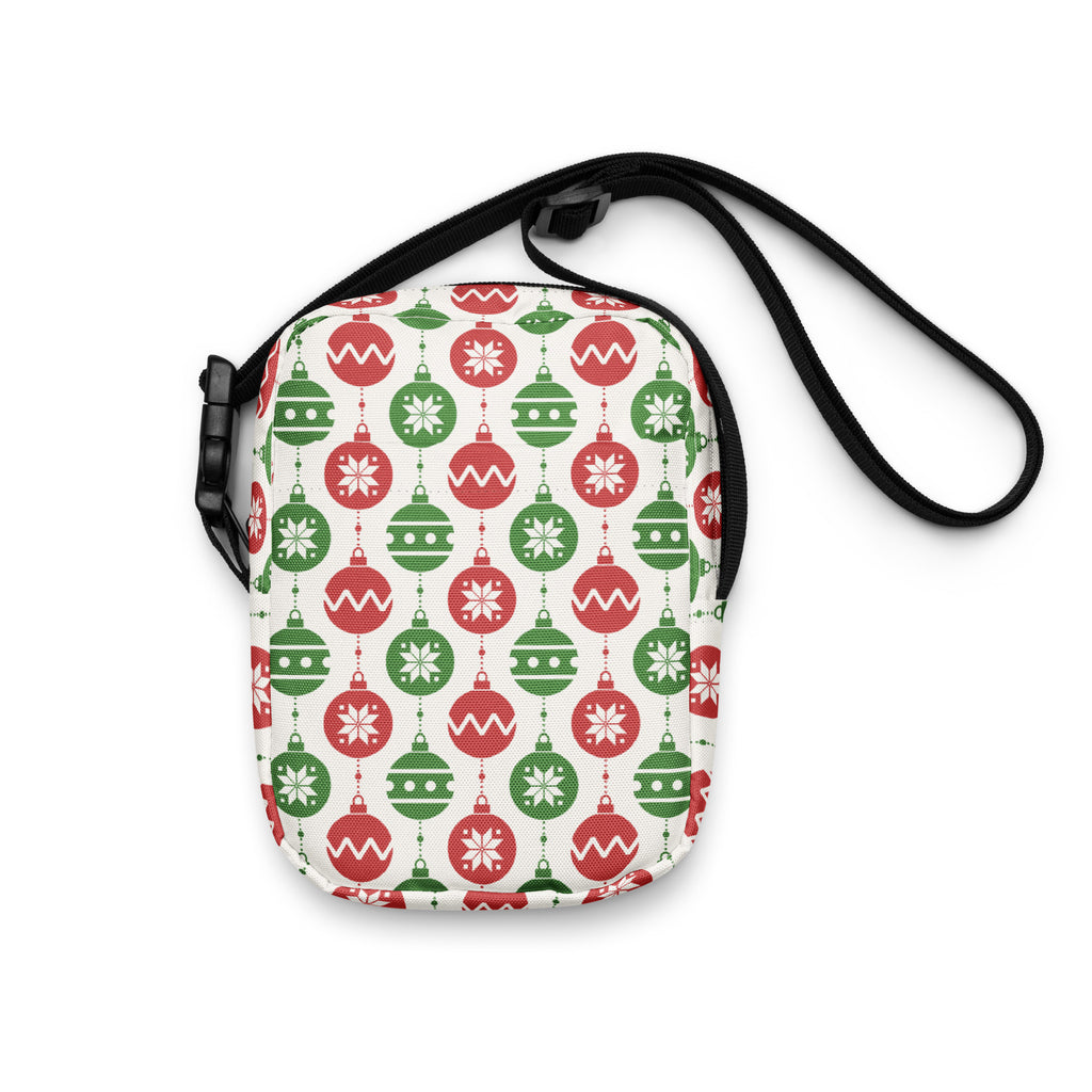 Girls christmas ornaments crossbody purse with festive red and green ornament pattern and black adjustable strap on cream background