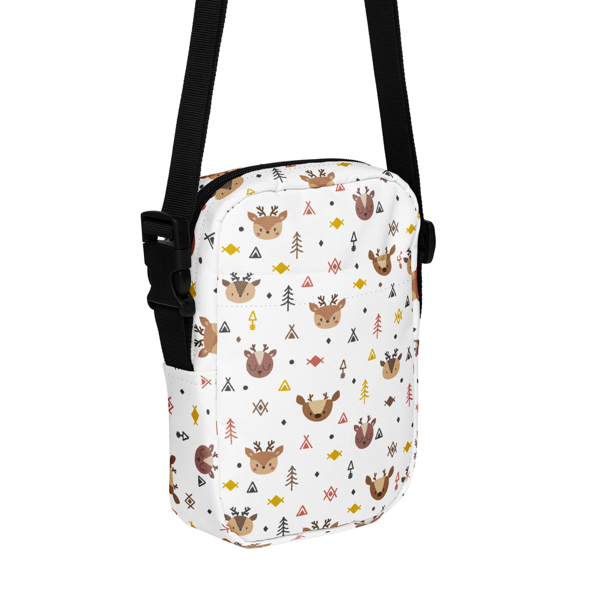 White crossbody bag with brown deer green trees and geometric shapes in yellow orange and black for Christmas use