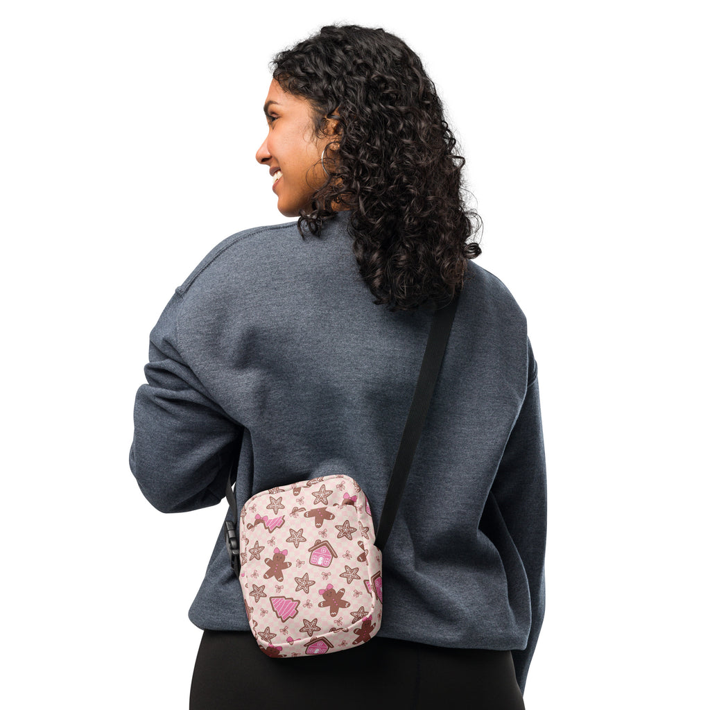 Pink gingerbread Christmas women’s crossbody purse with festive pattern of gingerbread men stars and cupcakes