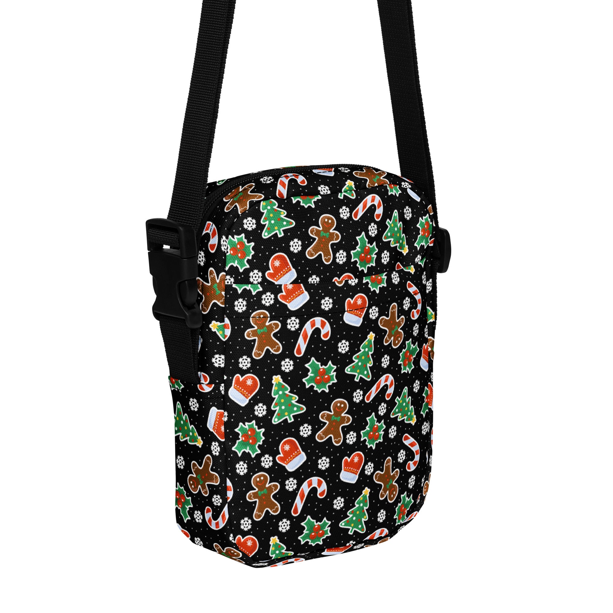 Black crossbody bag with festive gingerbread men candy canes christmas trees and mittens pattern for girls