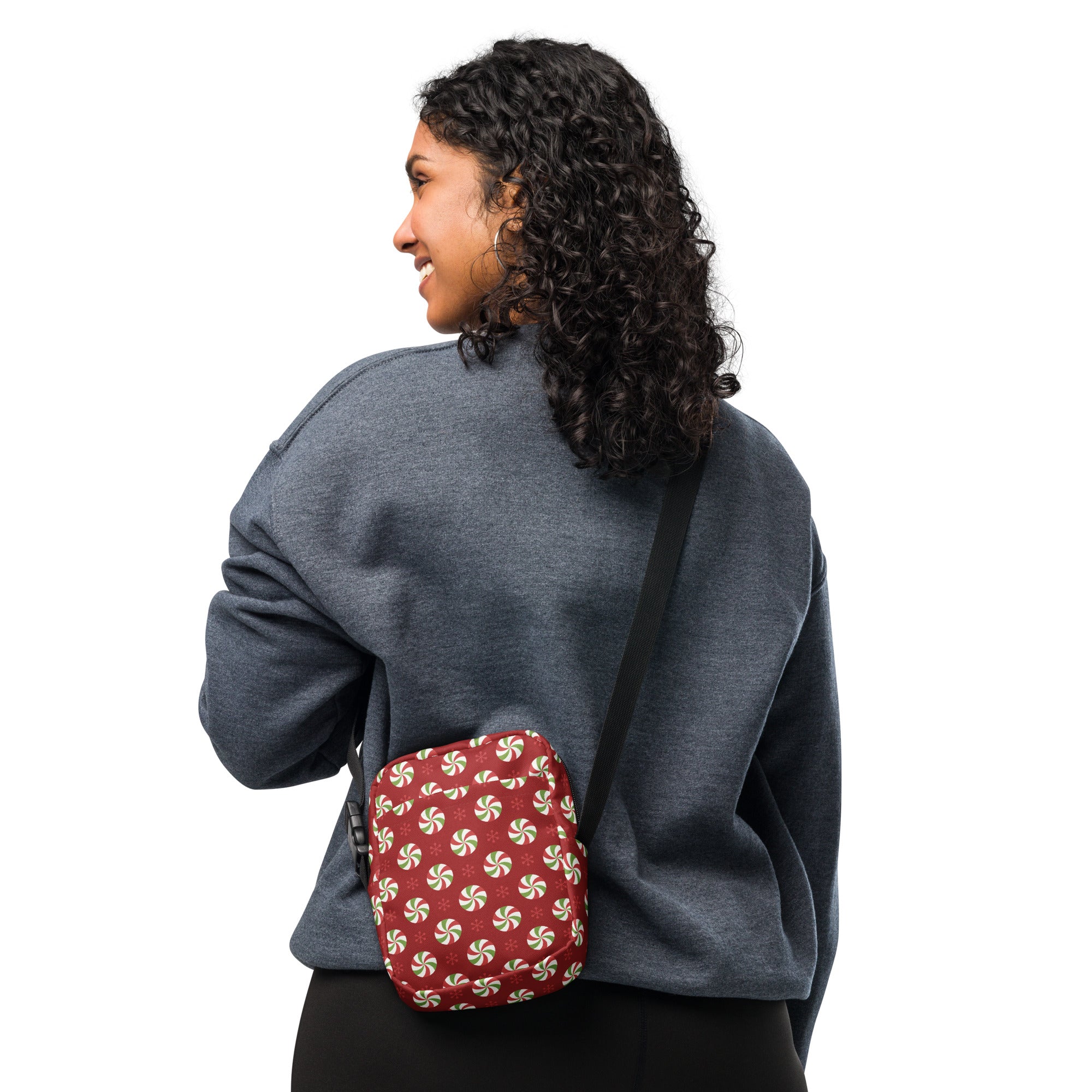 Red crossbody bag with white peppermint swirl pattern for stylish Christmas women’s use