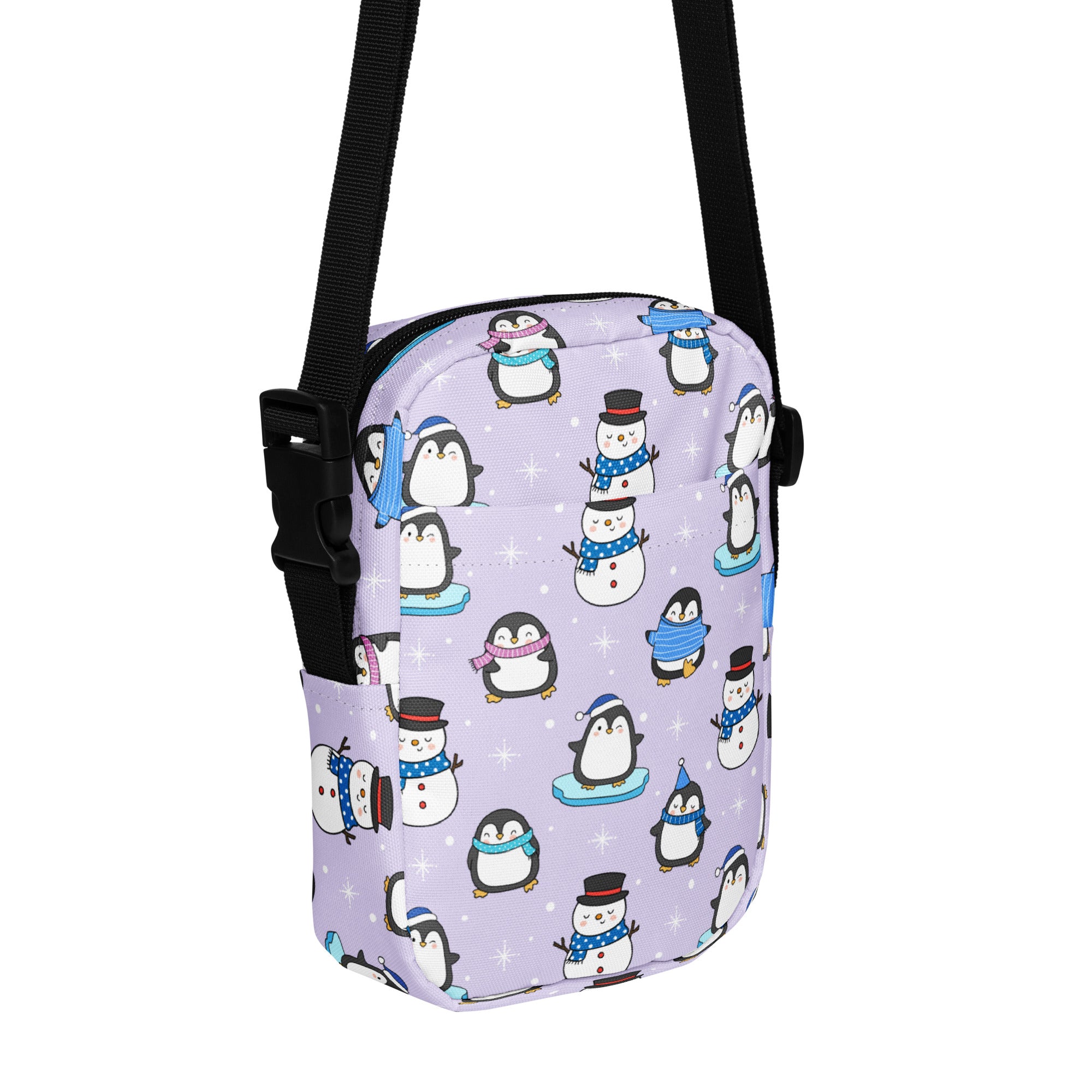 Girls winter penguin crossbody purse in lavender with playful cartoon penguins and snowmen pattern and adjustable strap
