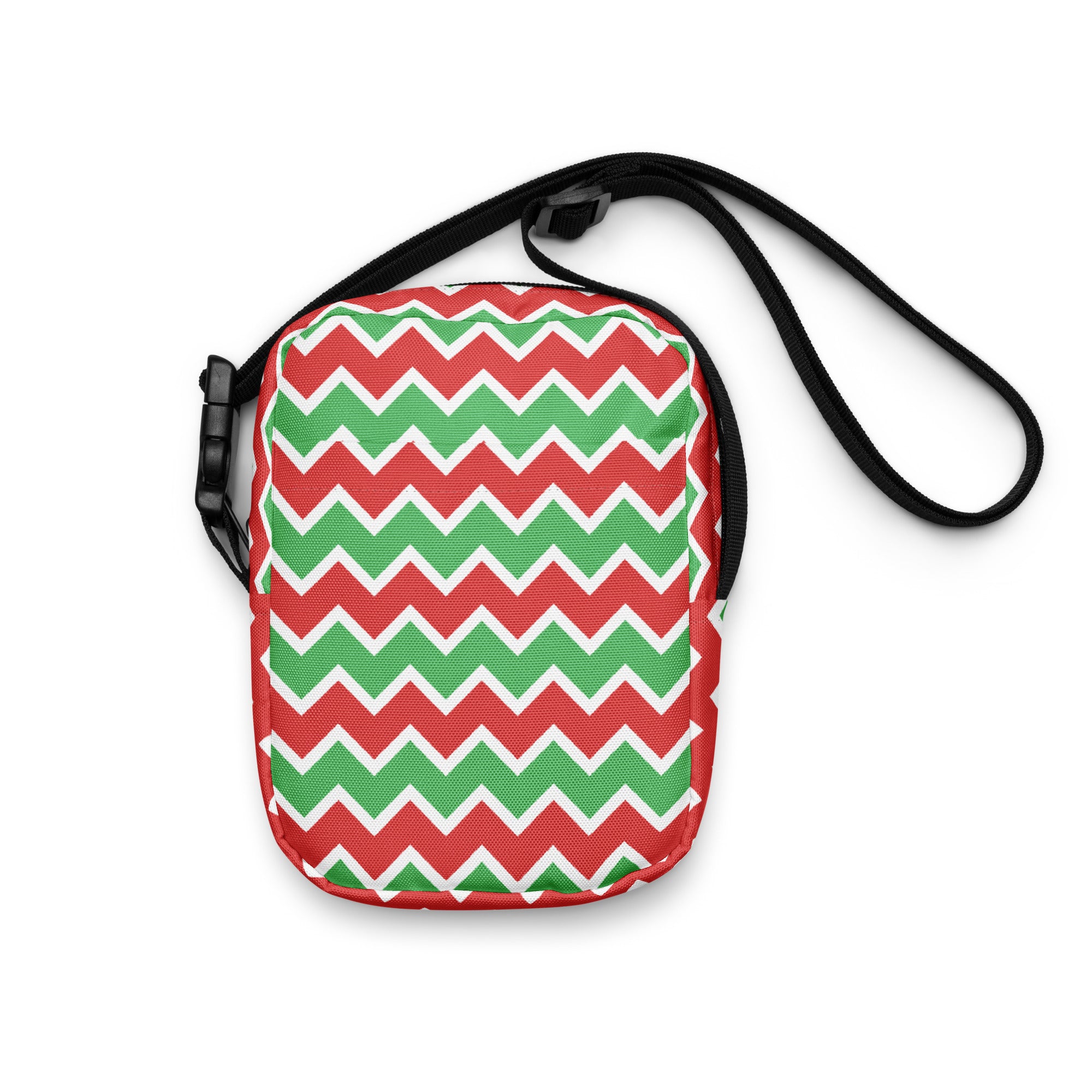 A festive red and green zigzag patterned Christmas women’s crossbody purse with a black adjustable strap