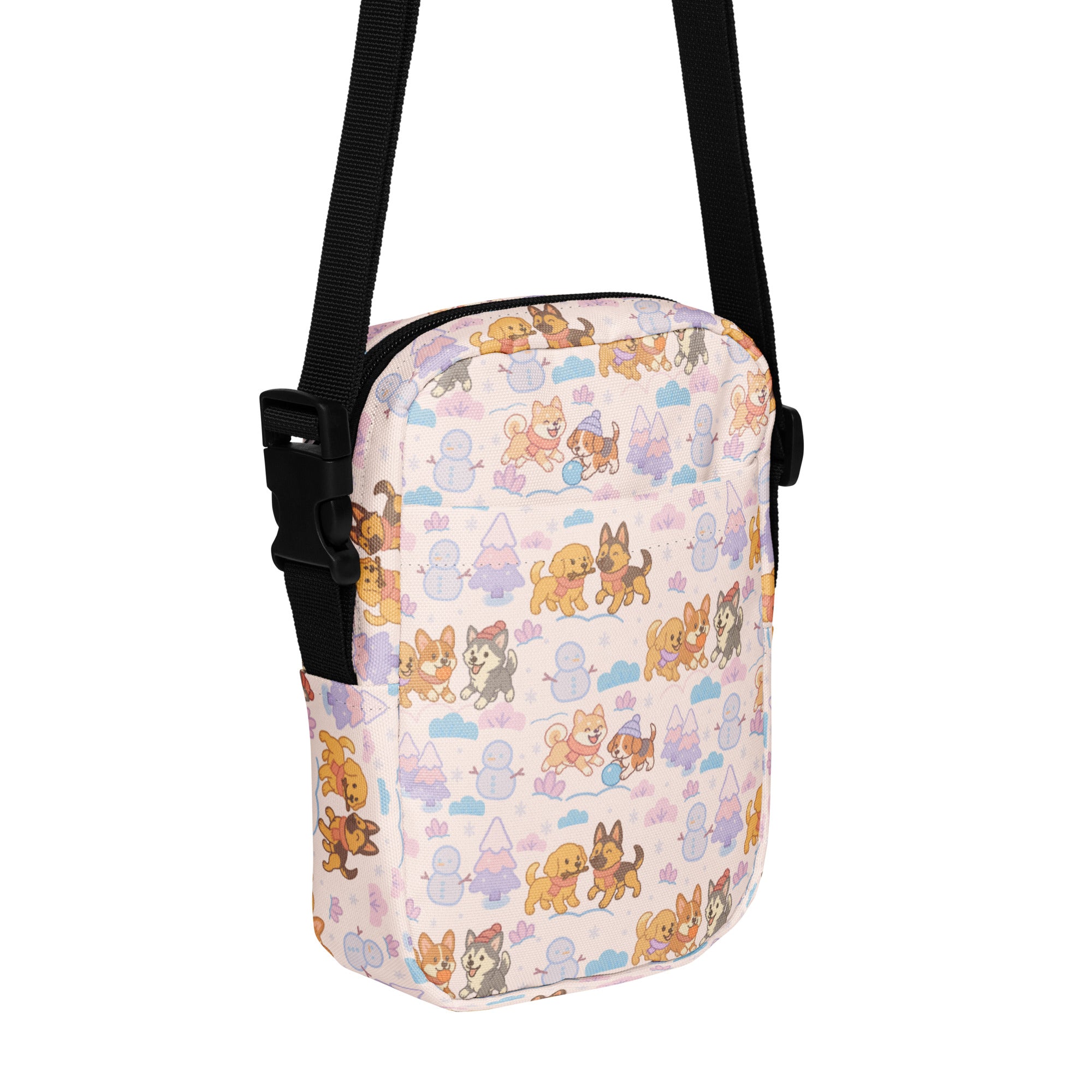 A pastel-colored girls winter dog crossbody purse with playful cartoon dog and snowman pattern on fabric surface