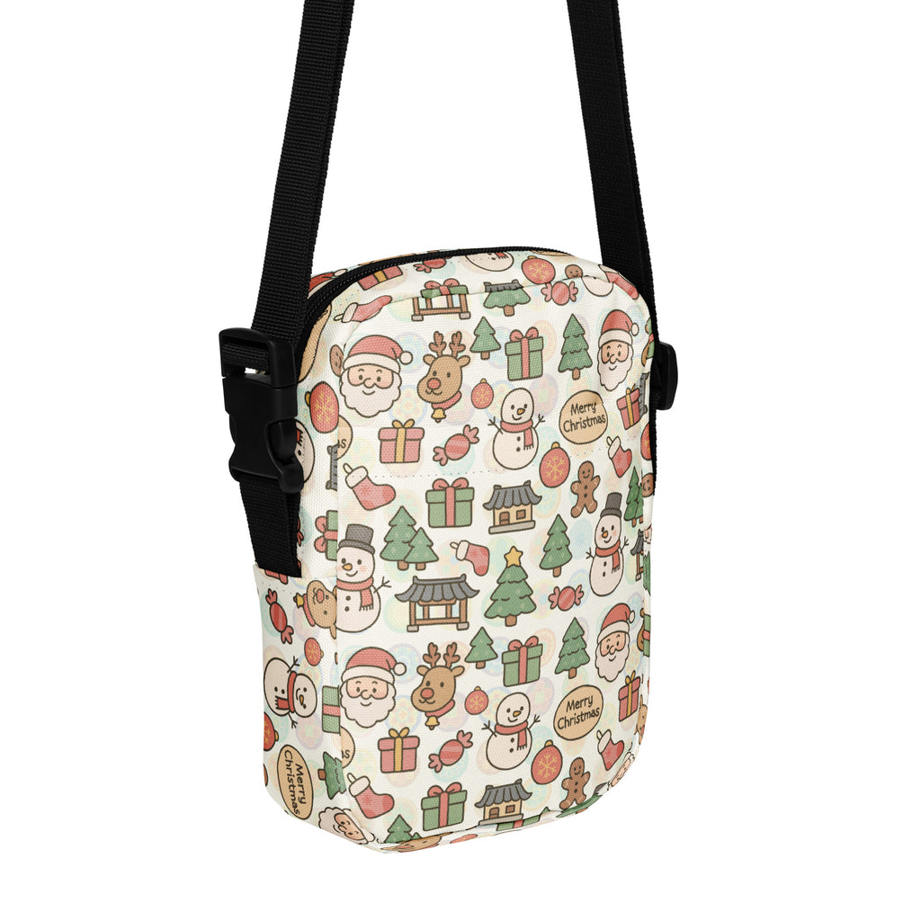 A festive white crossbody purse with santa claus, reindeer, snowmen, christmas trees, and gifts pattern in soft reds and greens