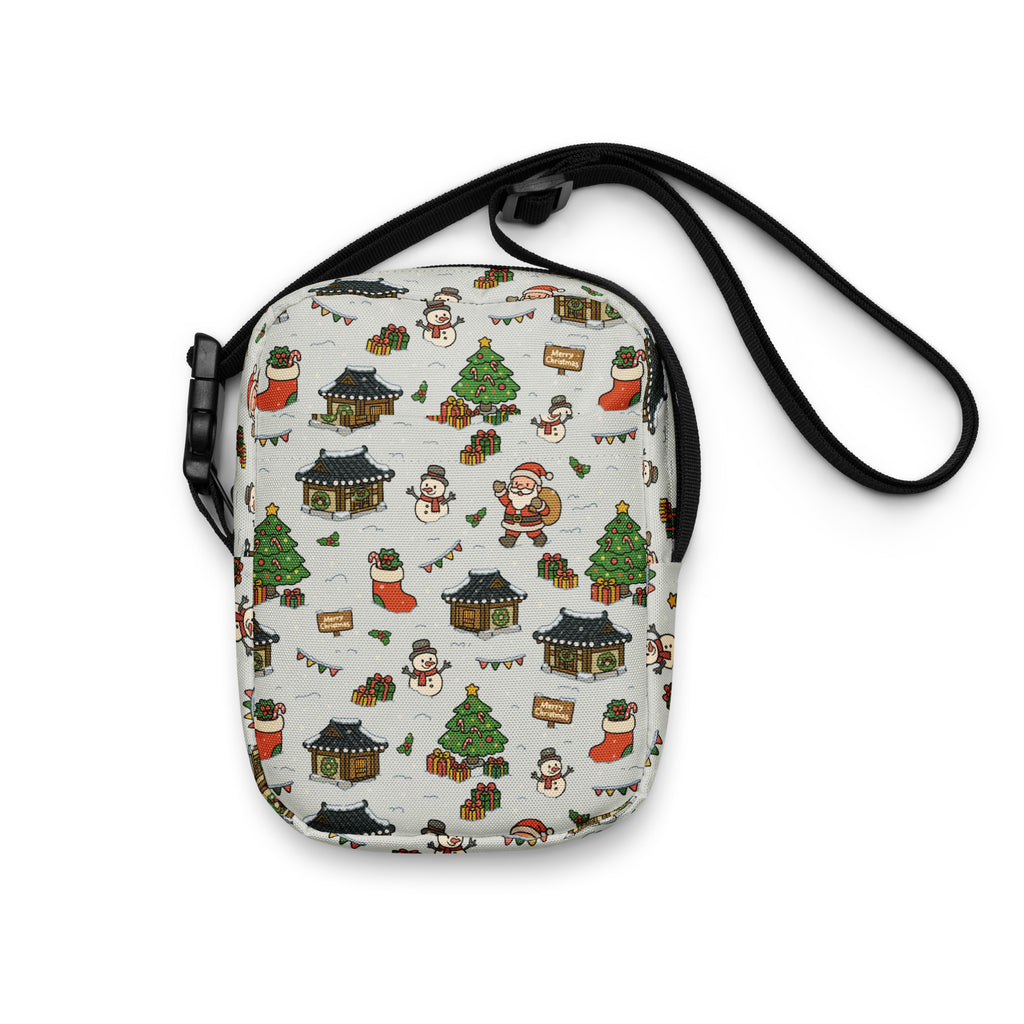 A light gray crossbody bag with festive Christmas print including snowmen santa trees and Korean-style houses