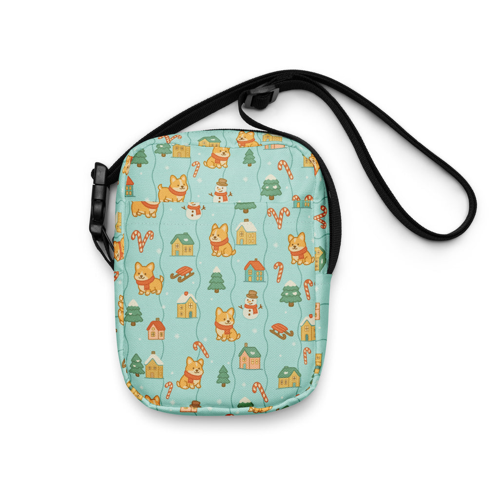A light blue Shiba Inu Christmas crossbody purse with festive orange corgis snowmen candy canes and tiny houses design
