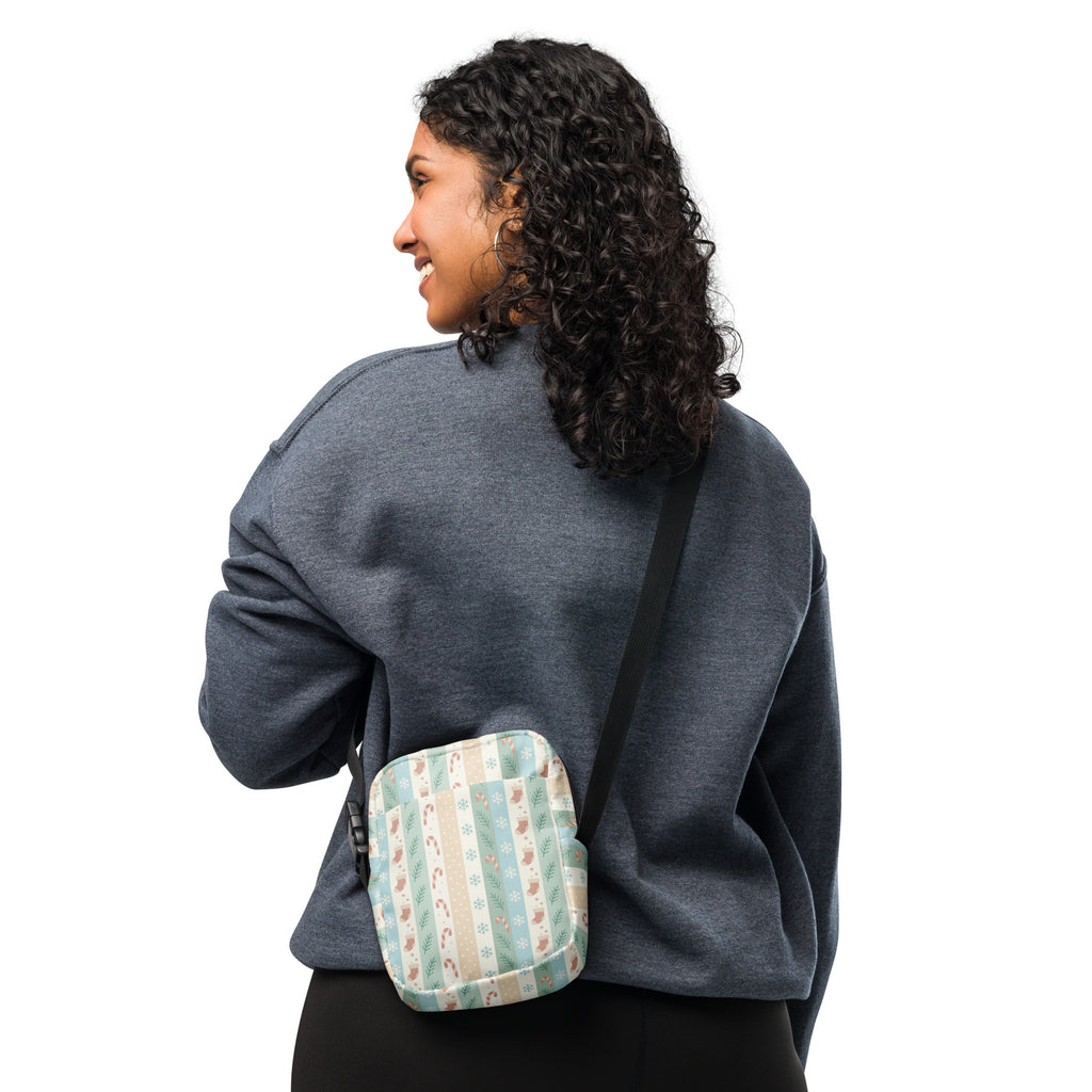 A cozy quilted crossbody bag in pastel Christmas stripes with candy cane and snowflake pattern in soft mint green beige and cream