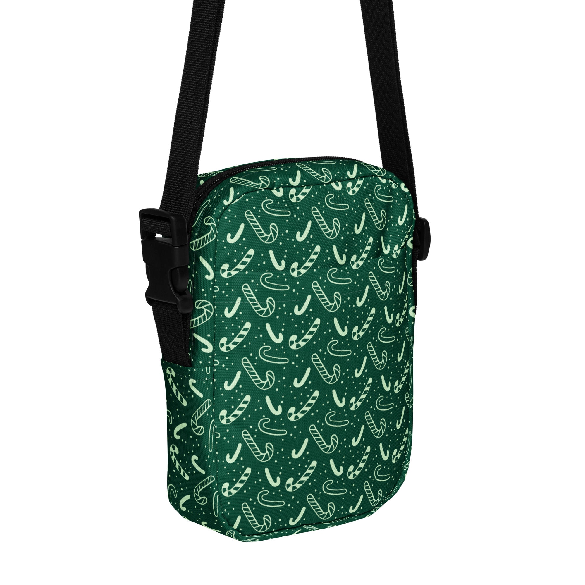 Girls green candy cane crossbody purse with black adjustable strap featuring a festive candy cane pattern