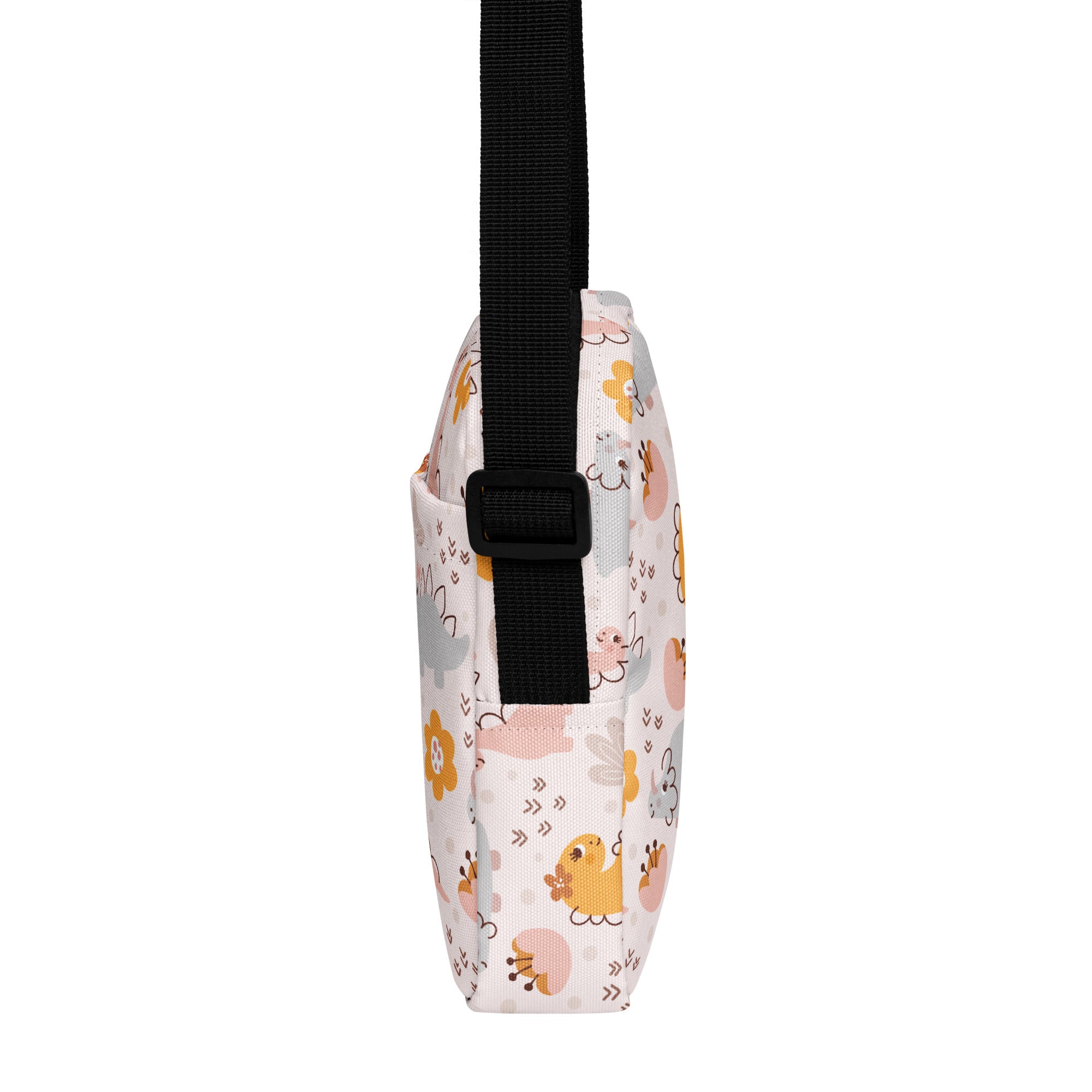 A white girls floral dinosaur crossbody purse with playful pastel cartoon animal patterns in yellow pink and gray