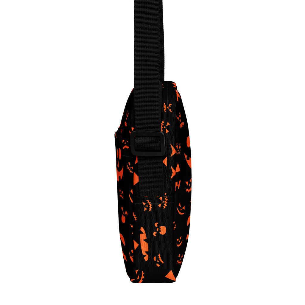 Black crossbody bag with orange jack-o-lantern faces pattern for girls halloween purse accessory