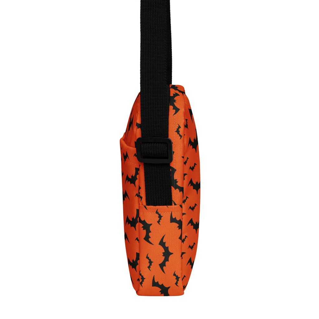 Kids orange crossbody fabric bag with black bat pattern and matching black strap for Halloween use