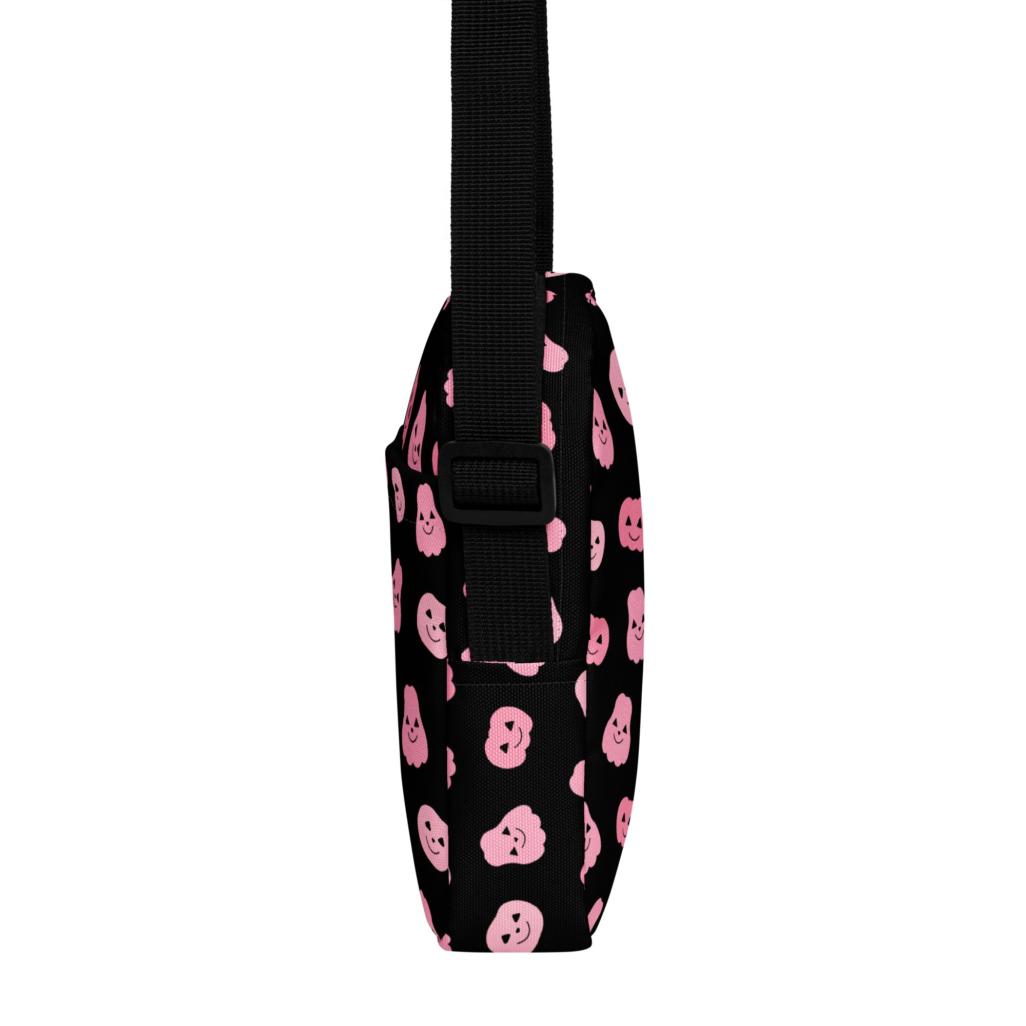 Black crossbody bag with pink smiling pumpkin faces and black adjustable strap for girls halloween use