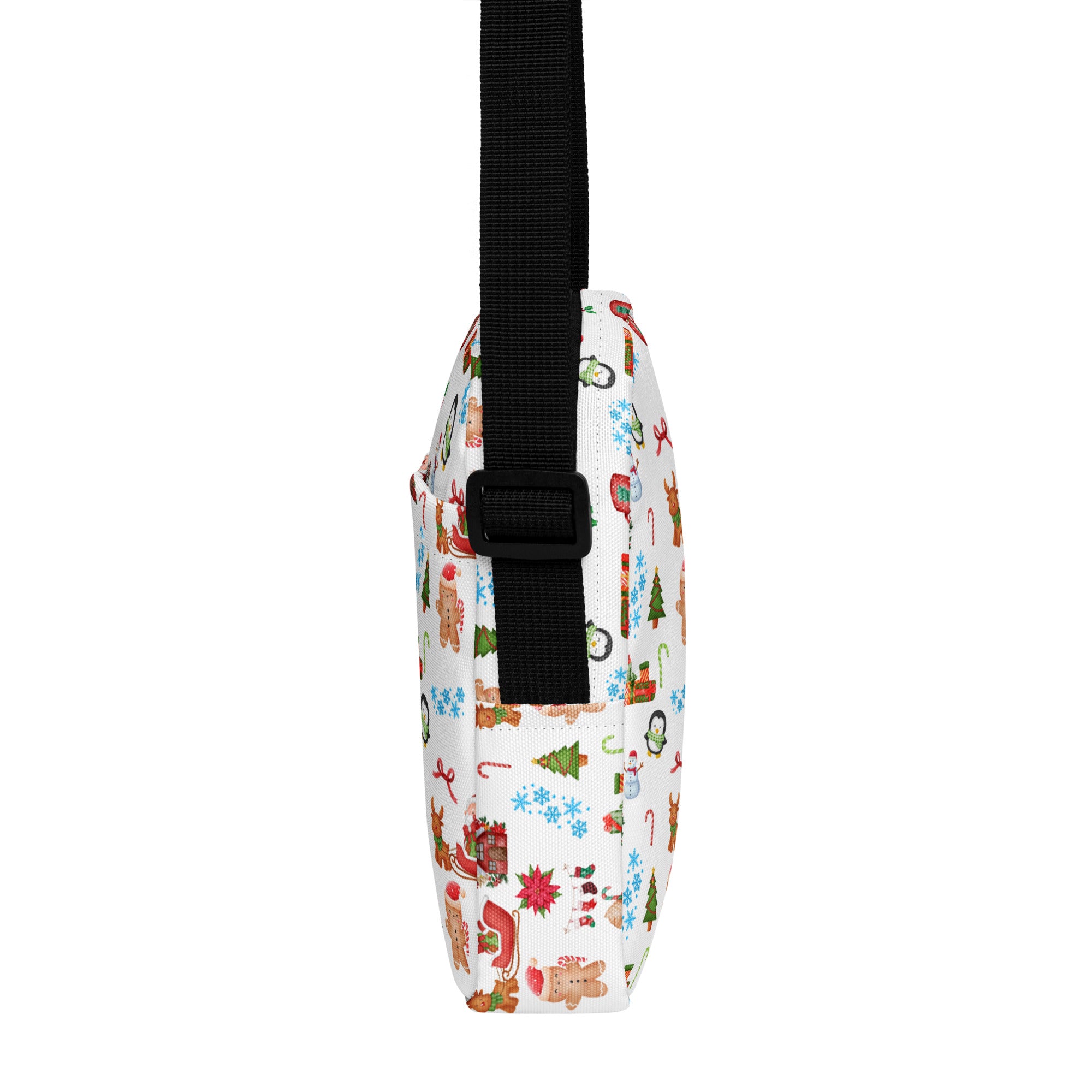 White girls christmas crossbody purse with festive gingerbread men candy canes and snowmen print on fabric surface
