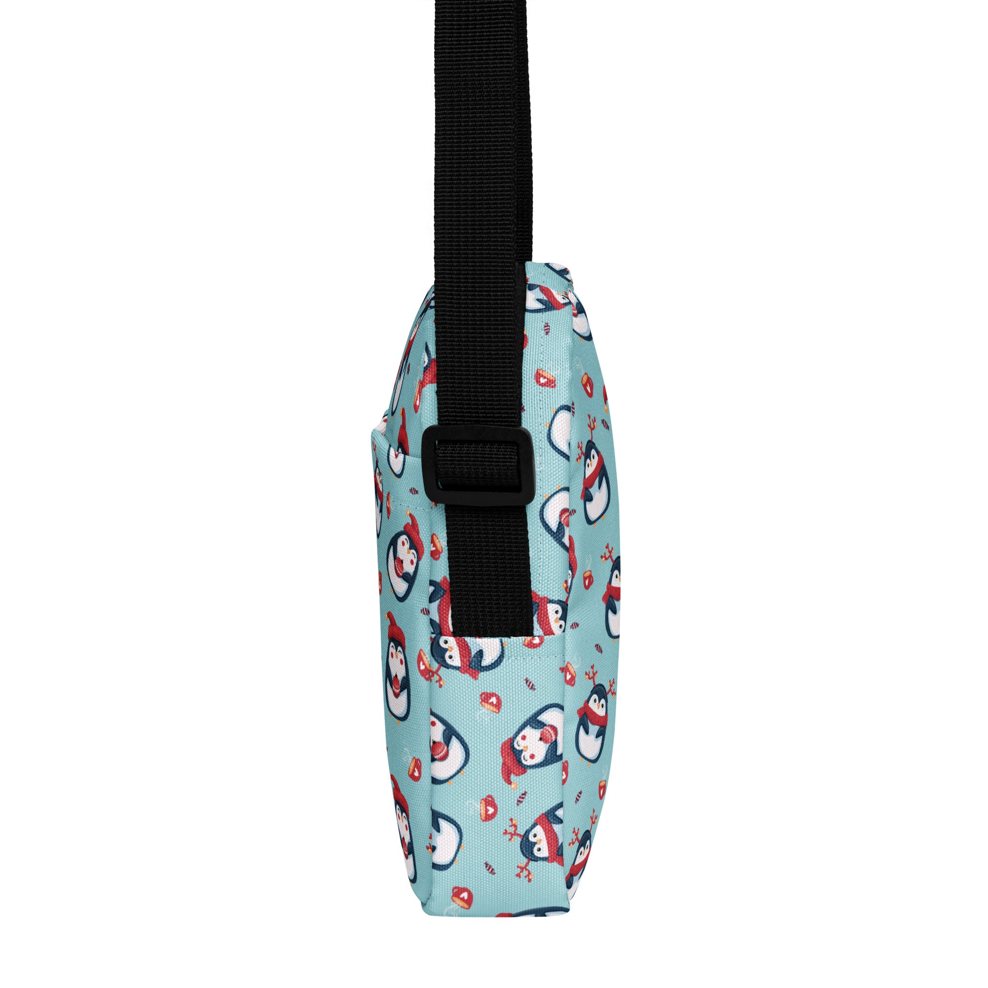 A light blue girls reindeer penguin crossbody purse with cartoon penguins in red scarves and candy motifs