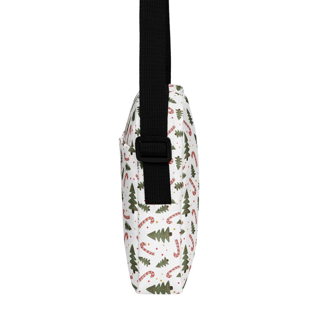 White crossbody purse with festive green pine tree and red white candy cane pattern and black adjustable strap