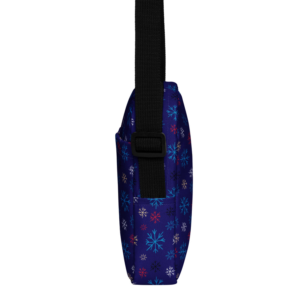 Girls navy crossbody purse with multicolor snowflake pattern in light blue white and pink fabric design