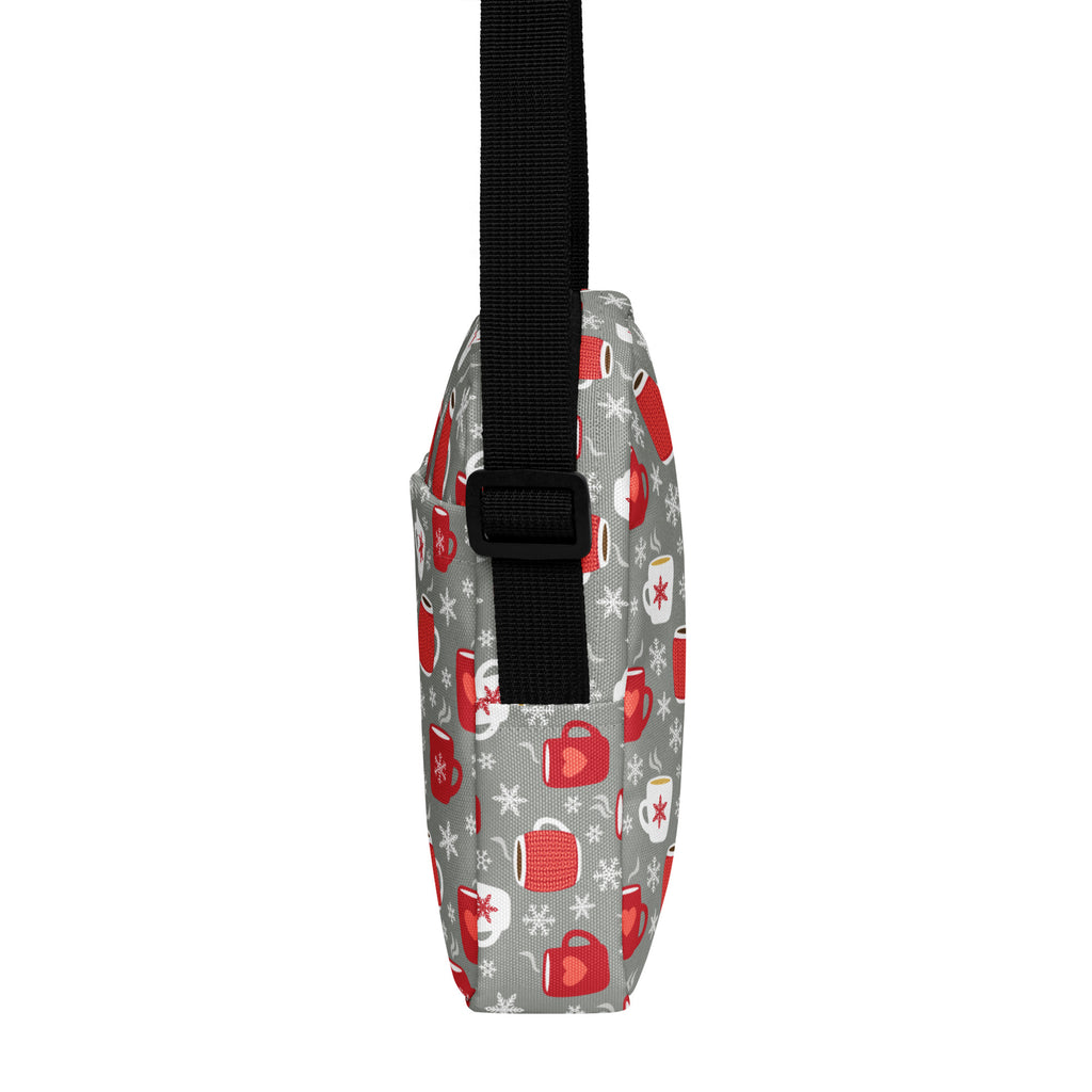 Gray crossbody bag with red and white mug and snowflake pattern and black adjustable strap for cozy winter use