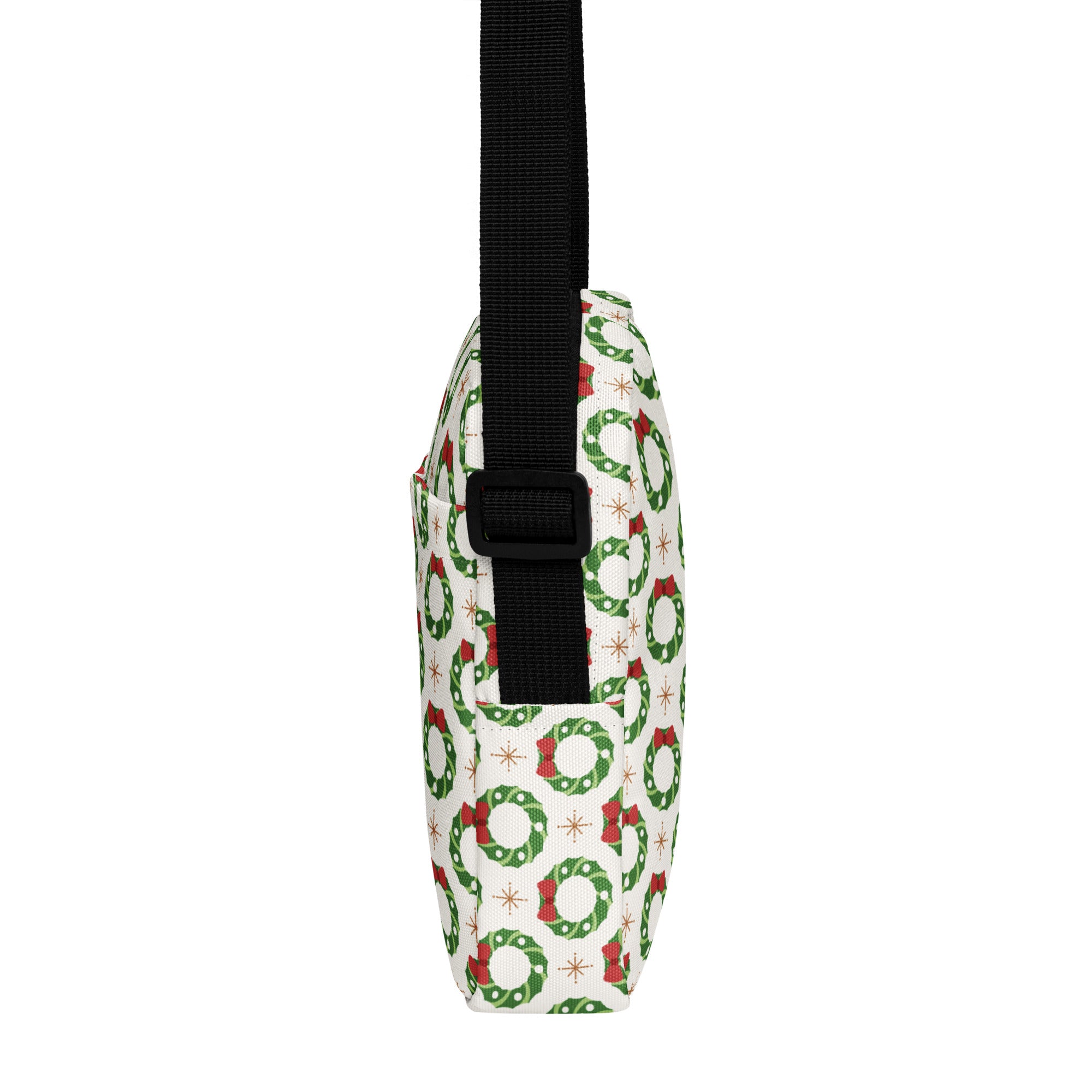 White crossbody purse with green wreath and red bow print on fabric with black adjustable strap for Christmas use