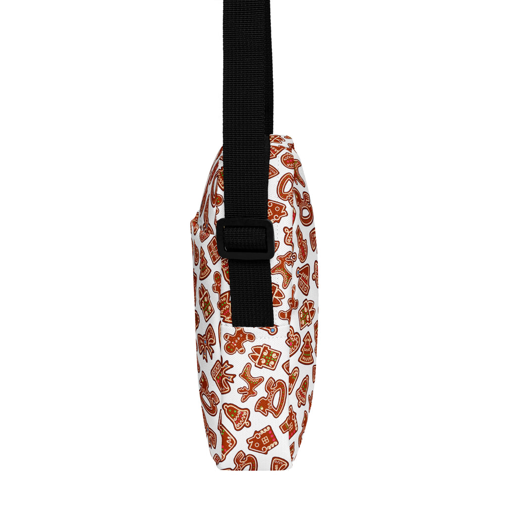 White crossbody bag with festive gingerbread cookie pattern in brown and orange with black adjustable strap