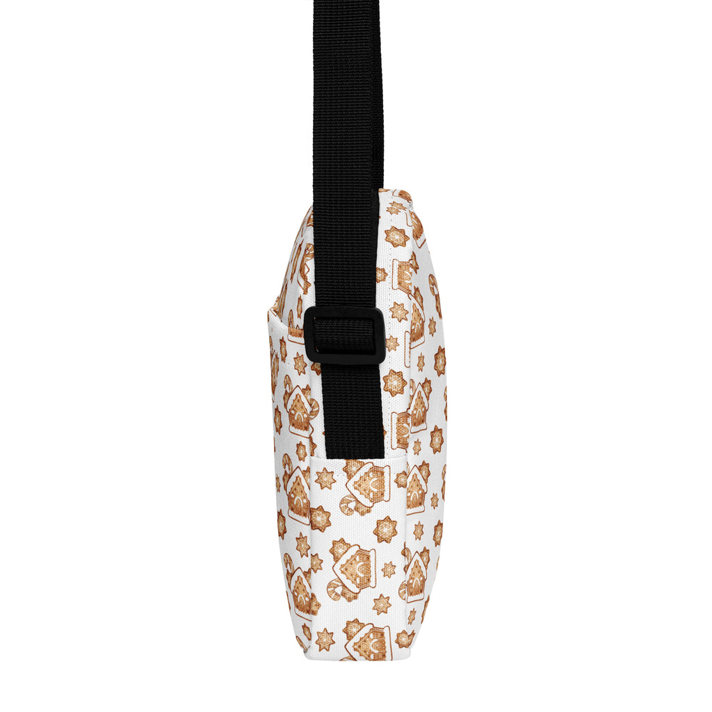 White crossbody bag with gingerbread house and star pattern in warm brown tones and black adjustable strap