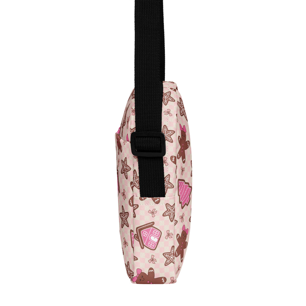 Girls pink gingerbread Christmas crossbody purse with black adjustable strap and festive gingerbread house and cookie patterns