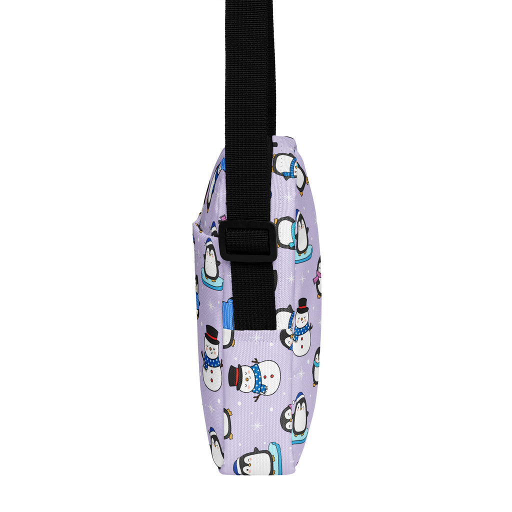 Lavender girls winter penguin crossbody purse with playful cartoon penguin and snowman pattern and black adjustable strap