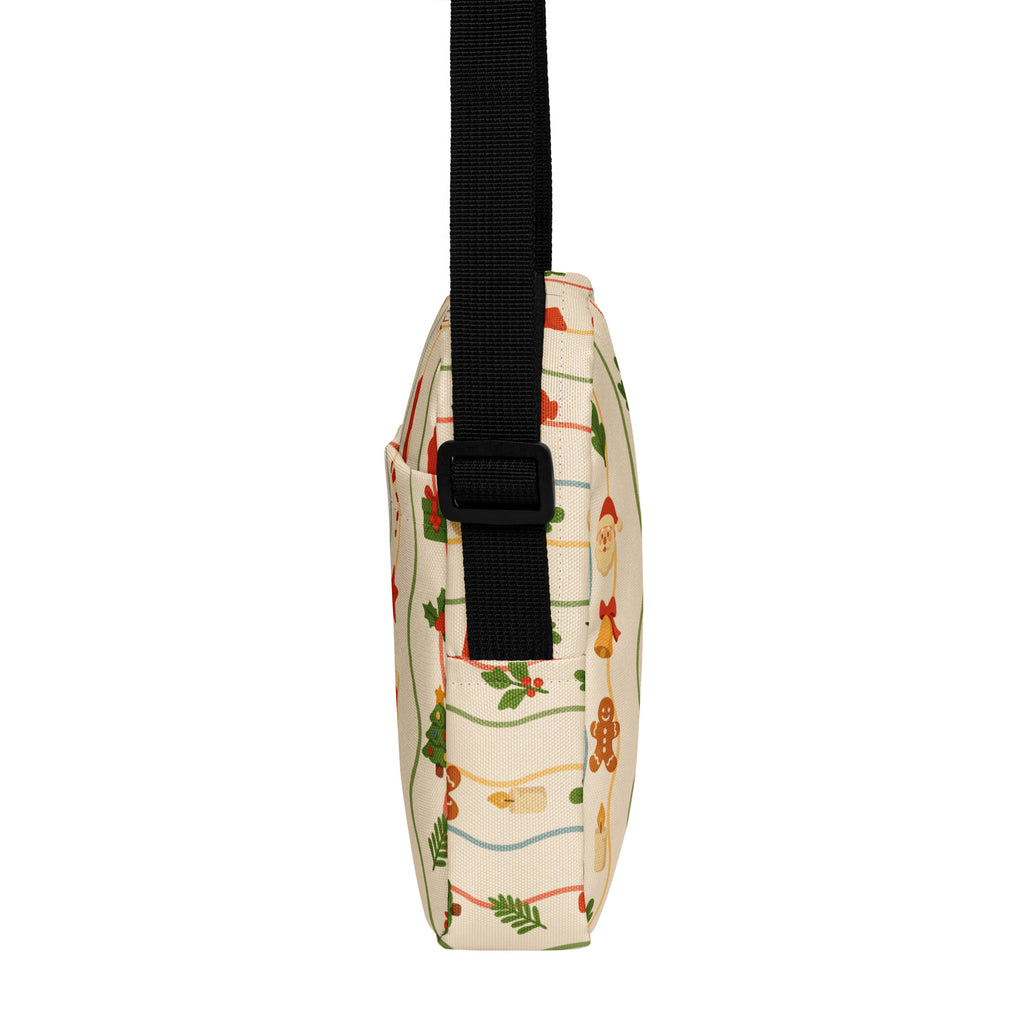 Christmas garland women’s crossbody purse cream-colored with playful holiday pattern of gingerbread men santa hats and holly leaves