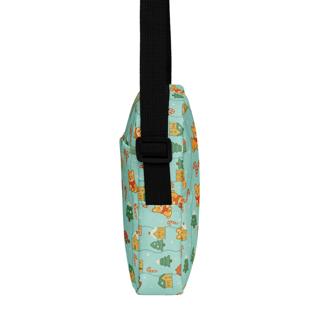 A light blue girls corgi winter wonderland crossbody purse with festive cartoon corgis candy canes and christmas trees pattern