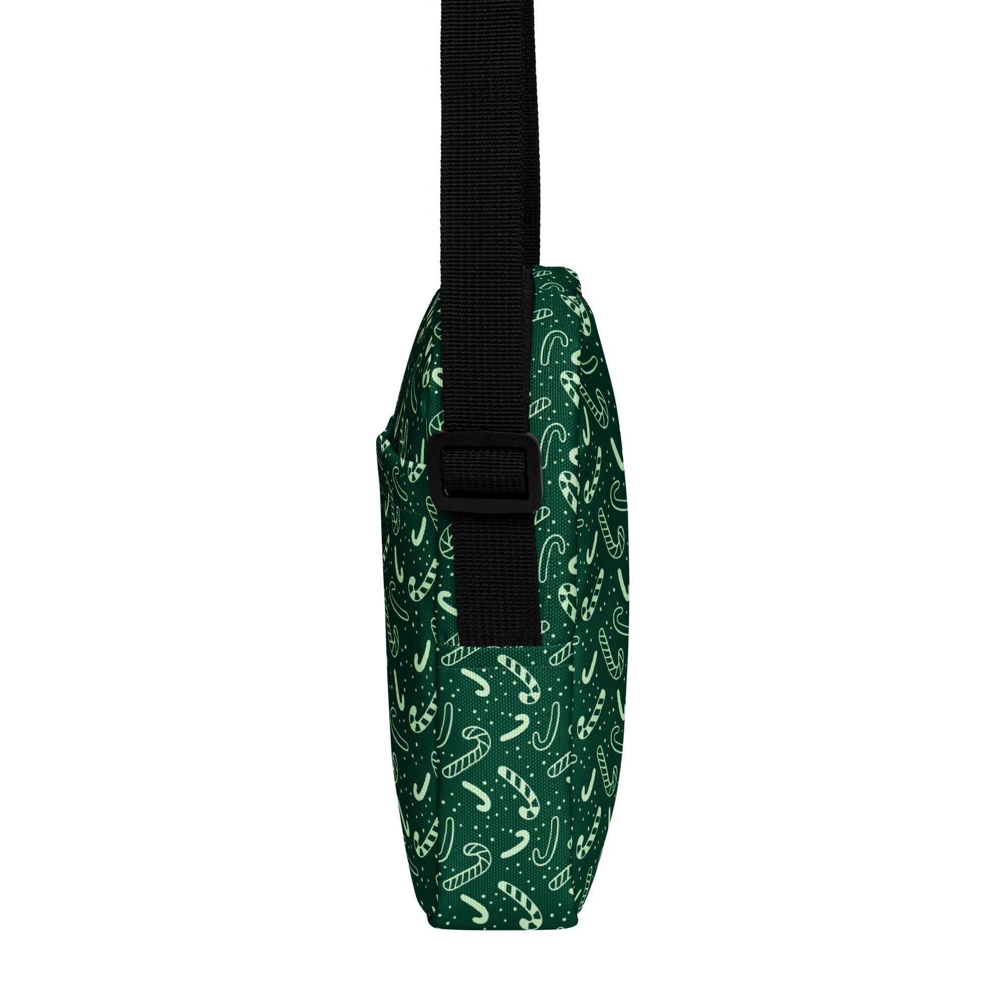 Dark green canvas crossbody bag with white candy cane and dot pattern and black adjustable strap for women