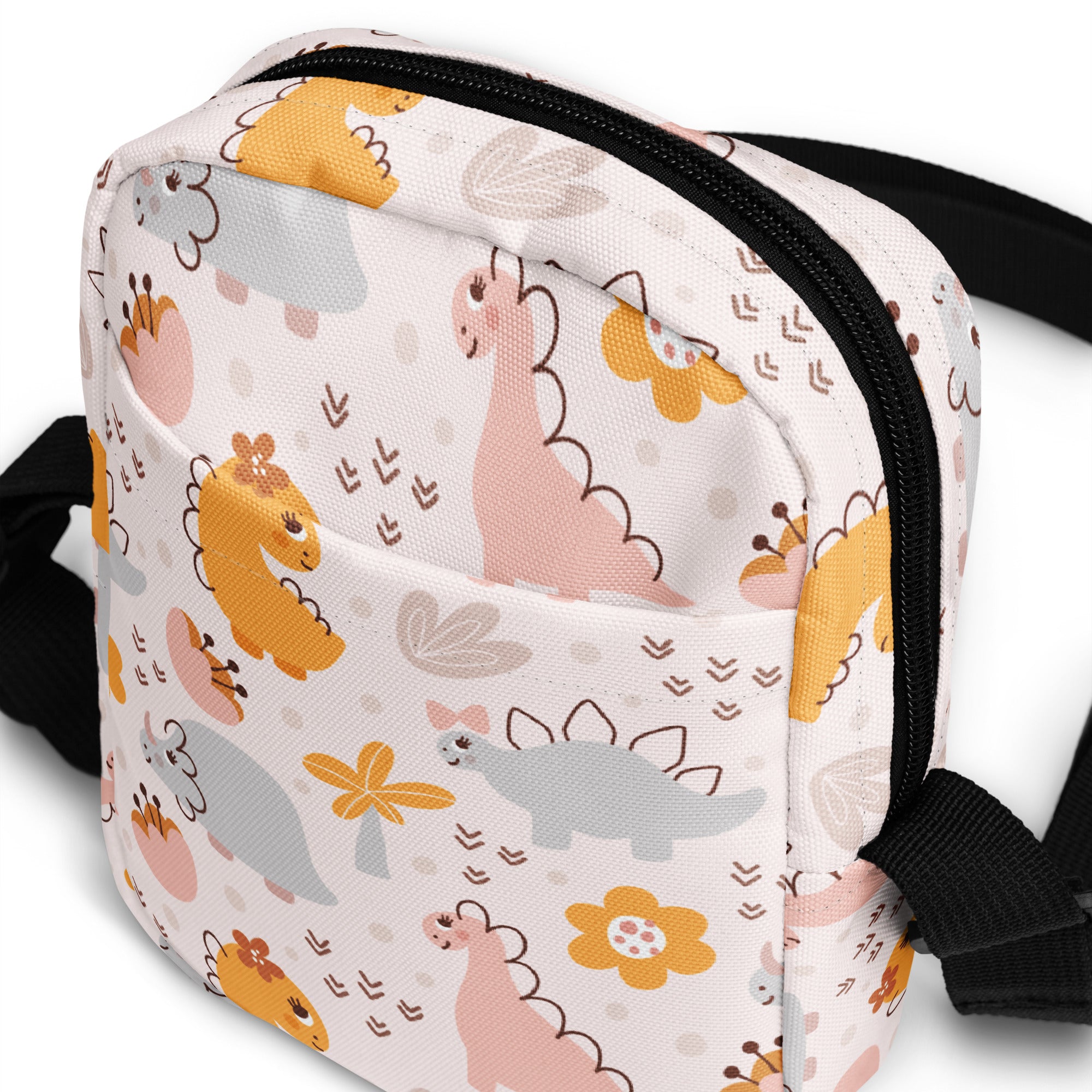 Girls floral dinosaur crossbody purse in white fabric with pastel cartoon dinosaurs flowers and black zipper trim