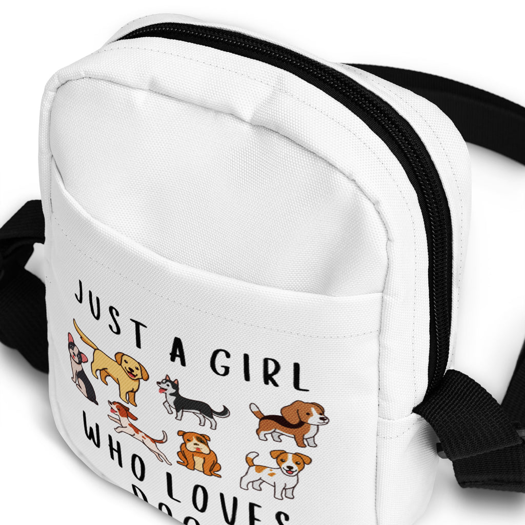 White canvas crossbody bag with black zipper and straps featuring playful dog breeds illustration and just a girl who loves dogs text