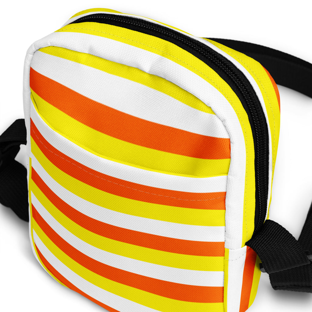 Girls candy corn stripes halloween crossbody purse with vibrant yellow orange white stripes and black zipper trim and straps